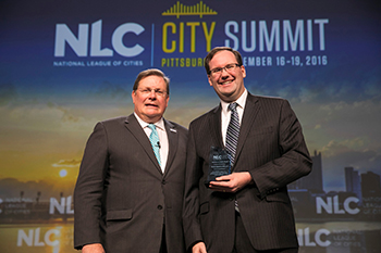Build America Mutual receiving award at 2016 city summit