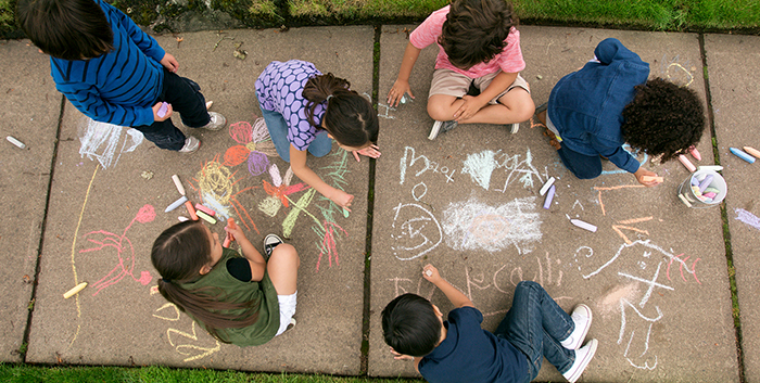 Children playing on sidewalk