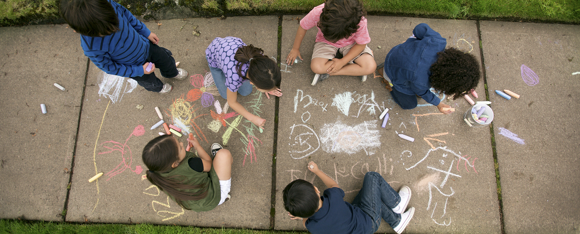 Kids play together on neighborhood sidewalk afterschool