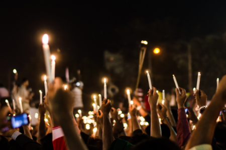 crowd holding candles