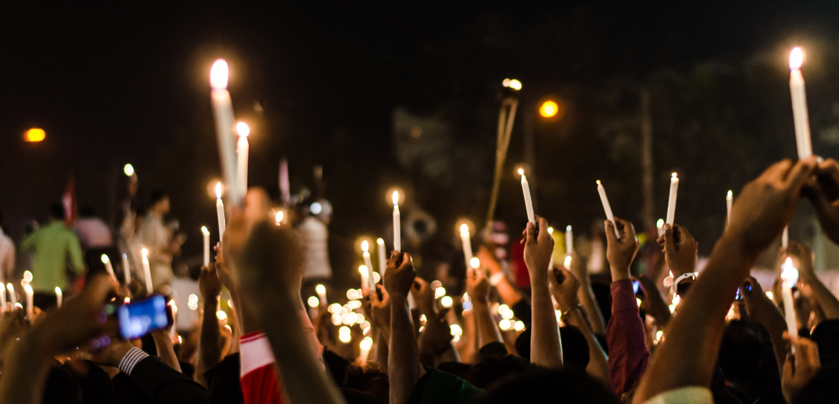 crowd holding candles